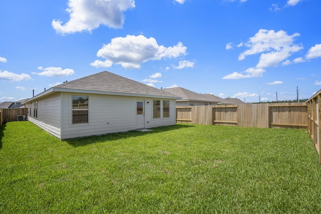 rear view of house featuring a lawn