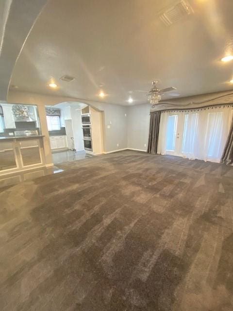 unfurnished living room with carpet floors and ceiling fan