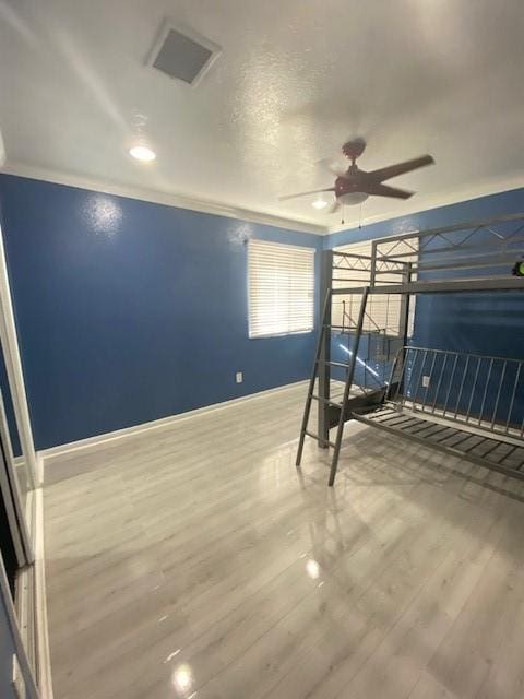 unfurnished bedroom featuring ornamental molding and wood-type flooring