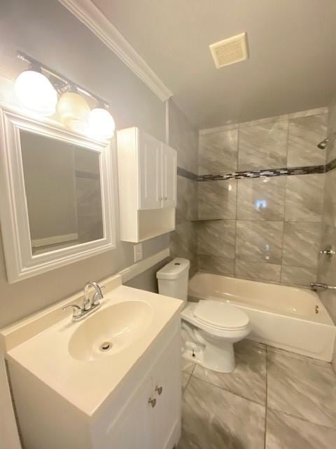 full bathroom with vanity, crown molding, toilet, and tiled shower / bath