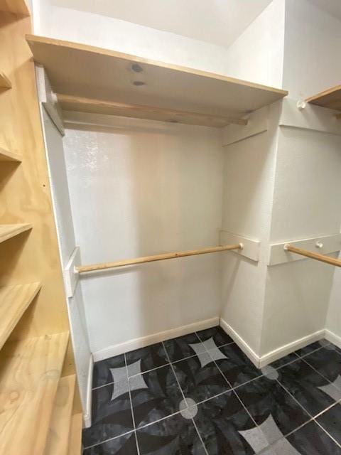 spacious closet with tile patterned floors