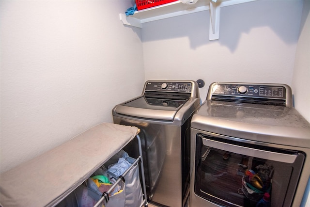 laundry room featuring washing machine and clothes dryer