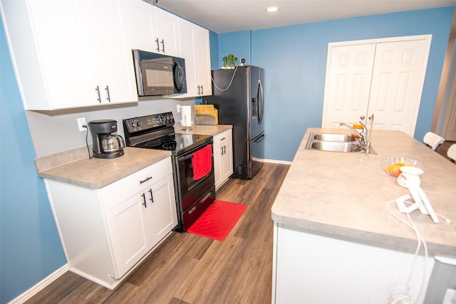 kitchen featuring white cabinetry, sink, dark wood-type flooring, and black appliances