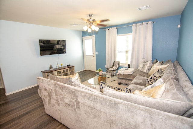 living room with ceiling fan and dark hardwood / wood-style flooring