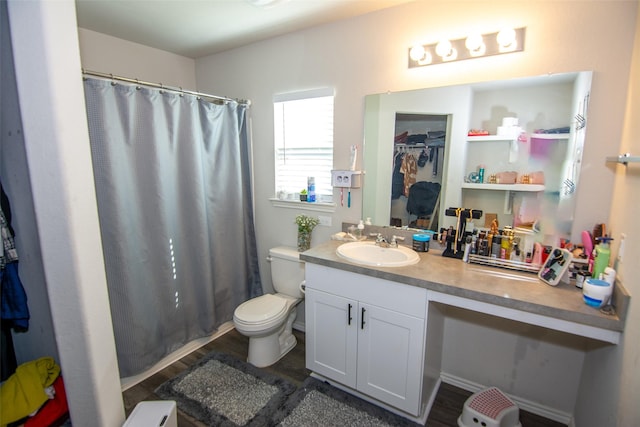 bathroom with vanity, toilet, and wood-type flooring