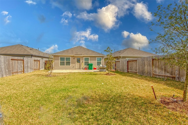 rear view of property with a lawn and a patio