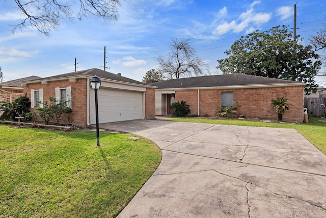 single story home featuring a garage and a front lawn