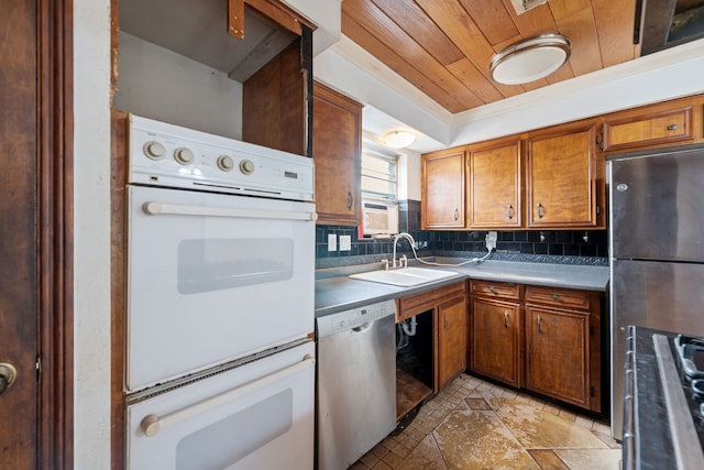 kitchen featuring appliances with stainless steel finishes, sink, backsplash, a tray ceiling, and wooden ceiling