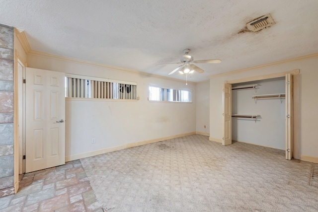 unfurnished bedroom featuring crown molding, ceiling fan, a textured ceiling, and a closet