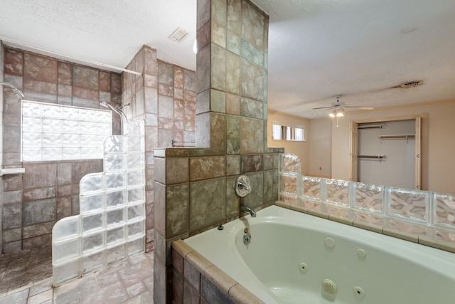 bathroom featuring tile walls, plus walk in shower, and ceiling fan