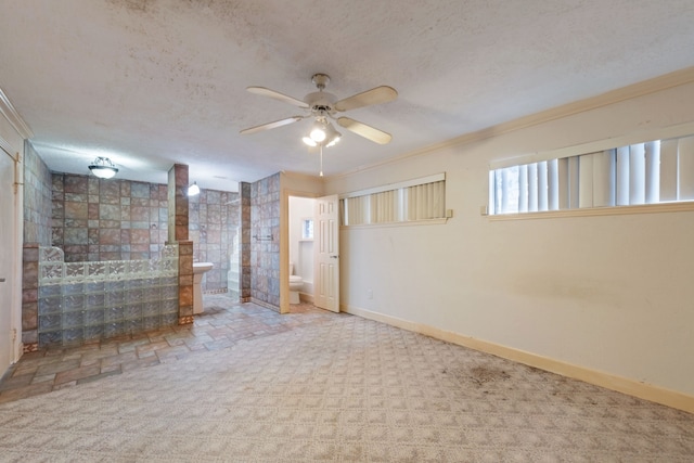 basement featuring crown molding, carpet floors, ceiling fan, and a textured ceiling