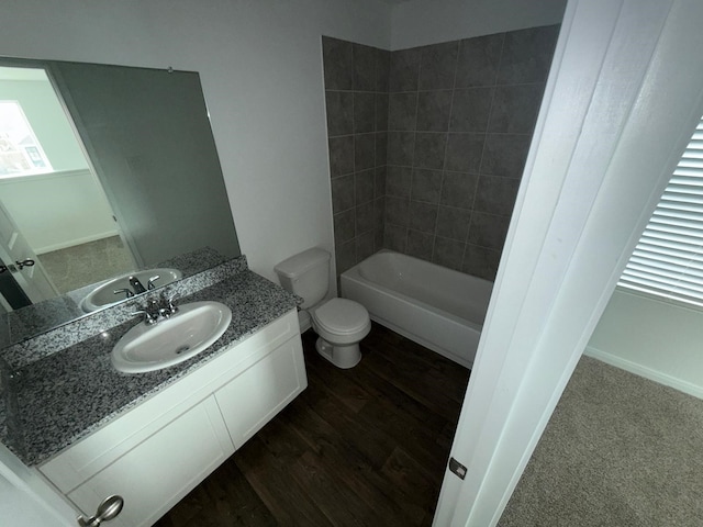 bathroom with vanity, wood-type flooring, and toilet