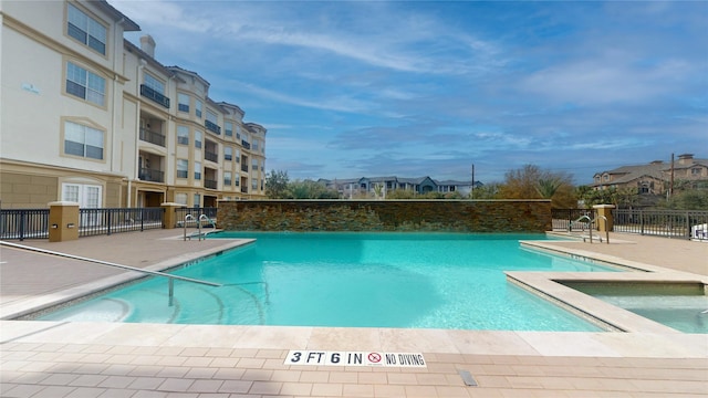 view of pool with a community hot tub and a patio area