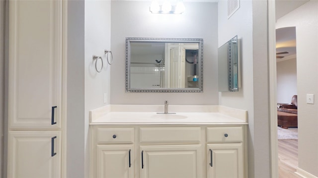 bathroom featuring vanity, wood-type flooring, and a shower