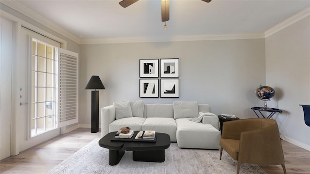 living room with crown molding, ceiling fan, and light wood-type flooring