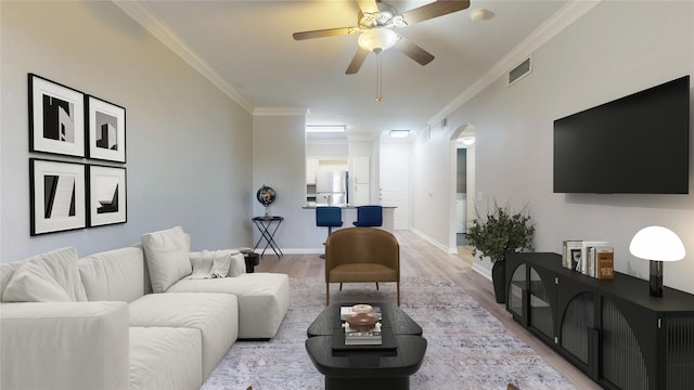 living room featuring crown molding, ceiling fan, and light wood-type flooring