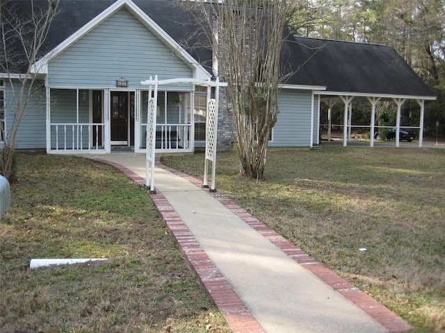 view of front of house with covered porch and a front yard