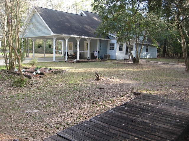 exterior space with a carport and cooling unit