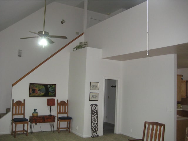 living room with carpet floors, high vaulted ceiling, and ceiling fan