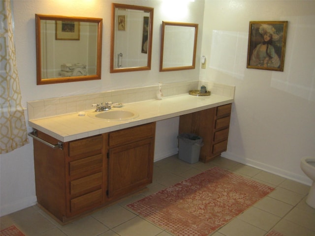 bathroom with vanity, backsplash, and tile patterned flooring