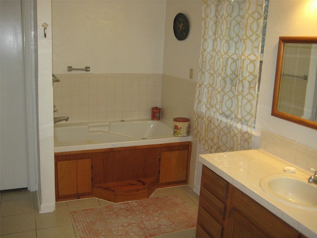 bathroom featuring a washtub, vanity, and tile patterned floors