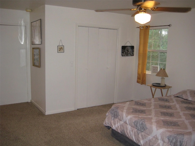 carpeted bedroom featuring a closet and ceiling fan