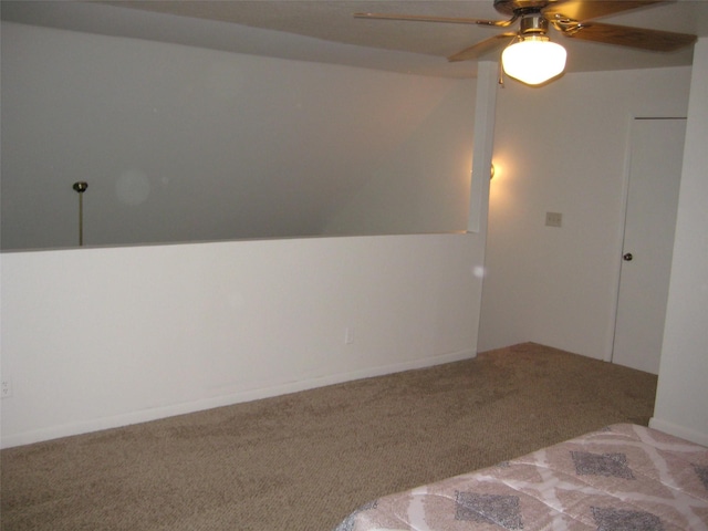 unfurnished bedroom featuring vaulted ceiling, ceiling fan, and carpet floors