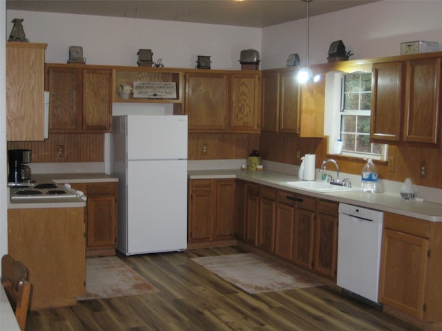 kitchen with white appliances, dark hardwood / wood-style flooring, and sink