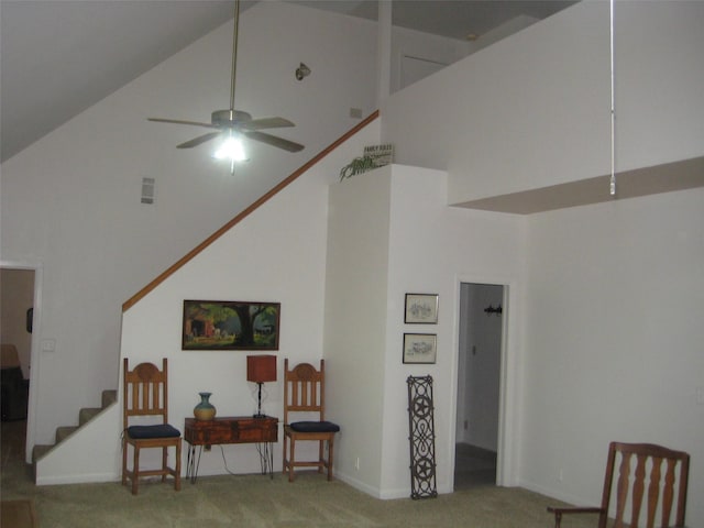 sitting room featuring ceiling fan, carpet flooring, and high vaulted ceiling