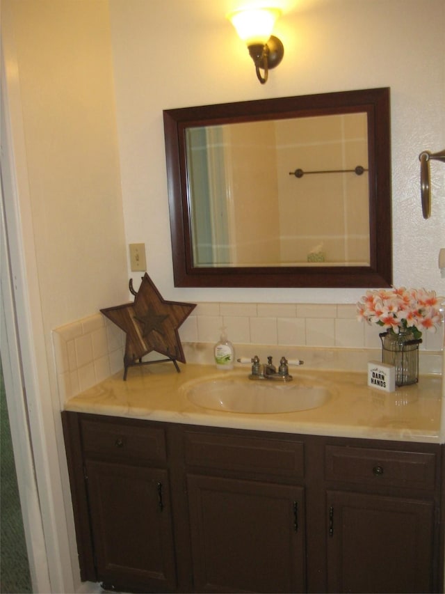 bathroom with vanity and tasteful backsplash