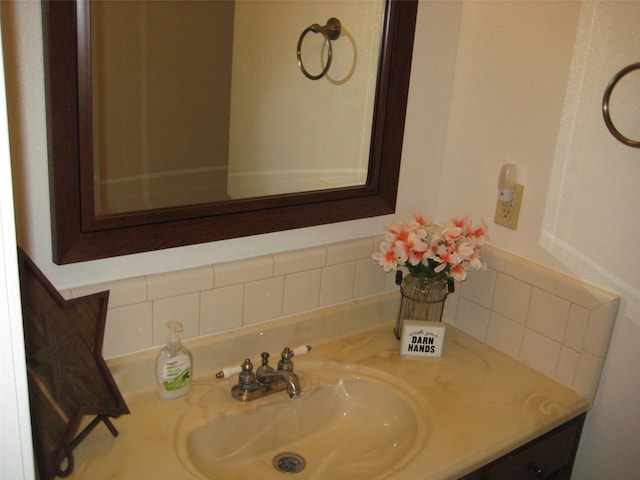 bathroom with tasteful backsplash and vanity