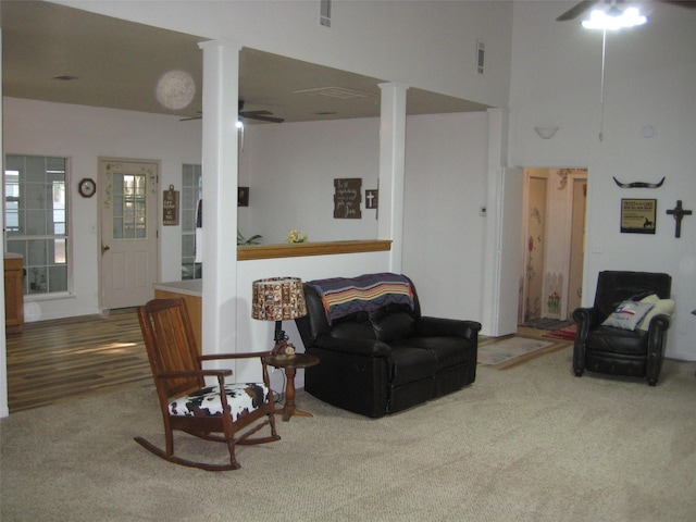 carpeted living room with ceiling fan