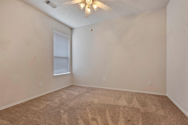 carpeted spare room featuring ceiling fan