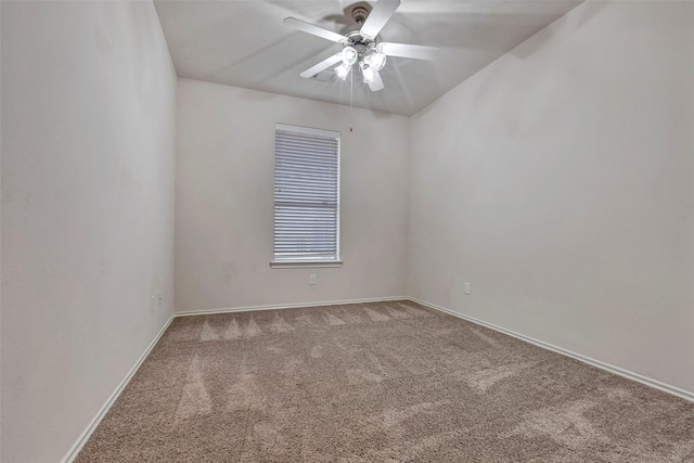 empty room with ceiling fan and carpet flooring