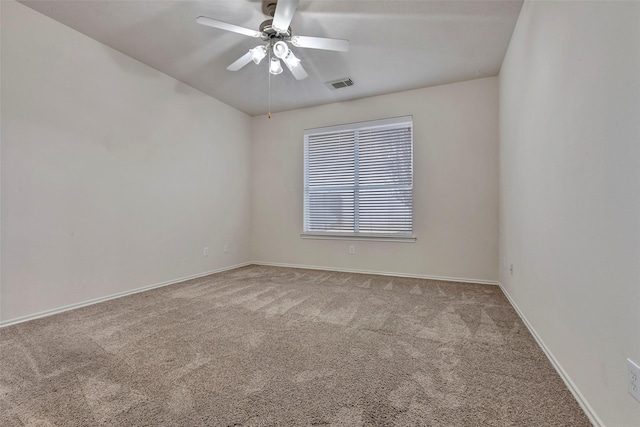 empty room featuring ceiling fan and light colored carpet