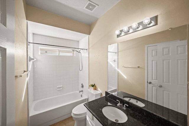 full bathroom featuring vanity, toilet, and tiled shower / bath combo