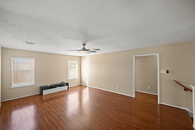 unfurnished living room with hardwood / wood-style flooring, ceiling fan, and a textured ceiling