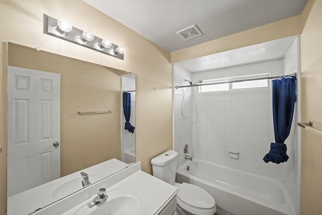 full bathroom with vanity, a textured ceiling, shower / bath combination with curtain, and toilet