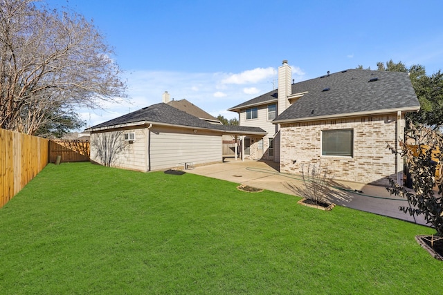 back of house featuring a patio area and a lawn