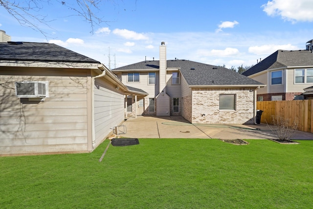 rear view of house featuring a patio and a lawn