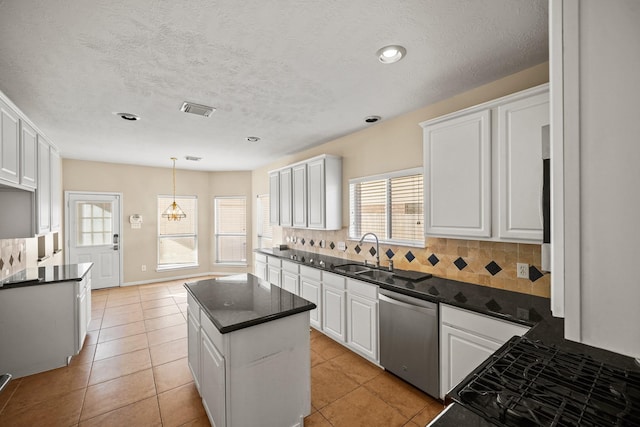 kitchen featuring white cabinetry, dishwasher, a kitchen island, and tasteful backsplash