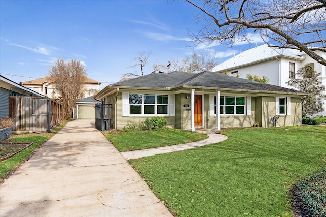 view of front of property featuring a garage, an outdoor structure, and a front lawn