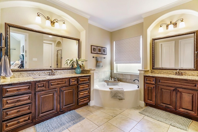 full bathroom with tile patterned flooring, two vanities, a sink, a bath, and crown molding