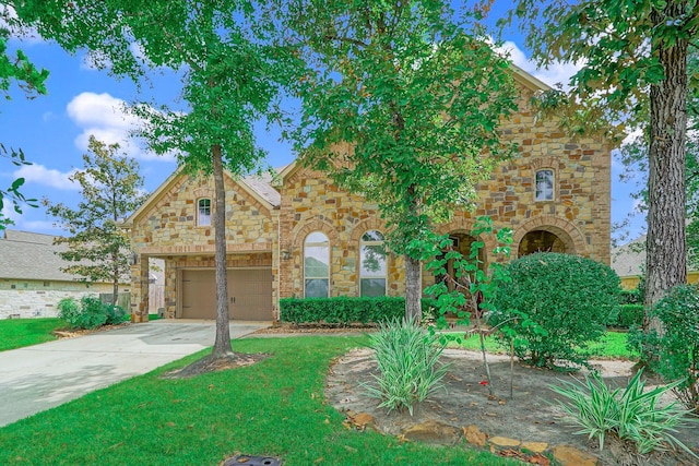 view of front of property featuring a front lawn, stone siding, an attached garage, and concrete driveway