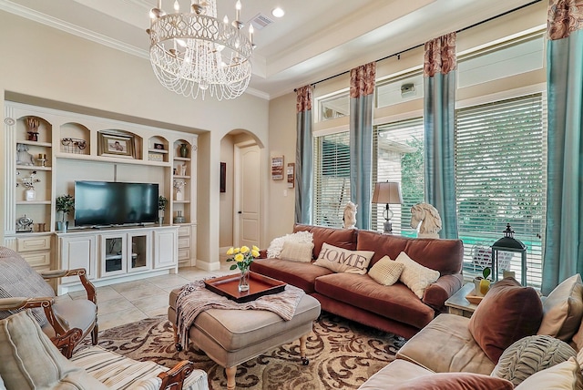 living room with arched walkways, light tile patterned floors, visible vents, ornamental molding, and a raised ceiling