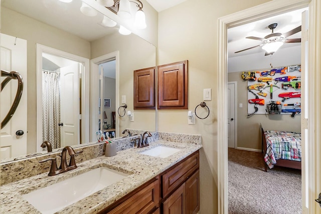 full bath featuring ceiling fan with notable chandelier, a sink, ensuite bath, and double vanity