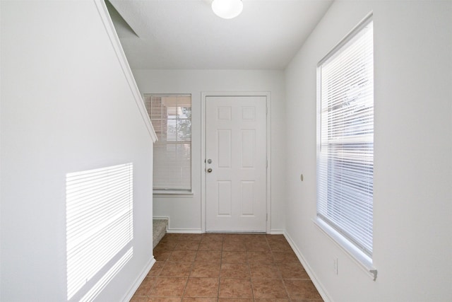 doorway with tile patterned floors and a wealth of natural light