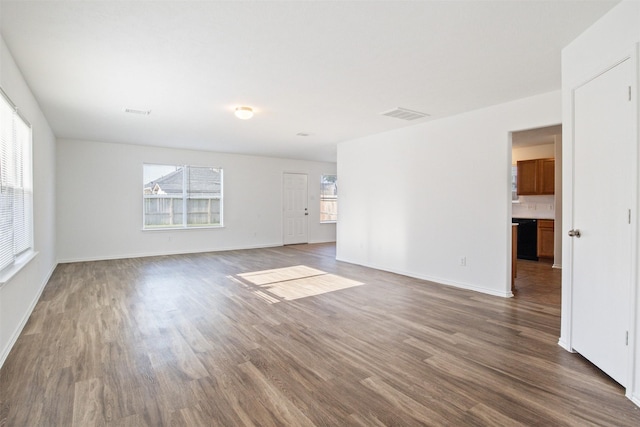 unfurnished room featuring dark hardwood / wood-style floors and a wealth of natural light