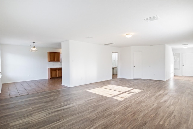 unfurnished living room featuring wood-type flooring