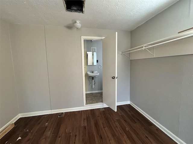 walk in closet featuring dark hardwood / wood-style flooring and sink